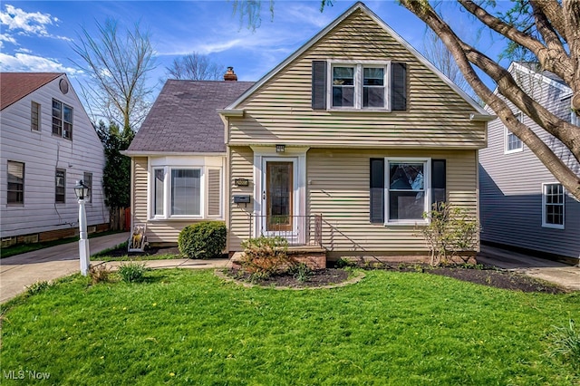 bungalow with a chimney and a front yard