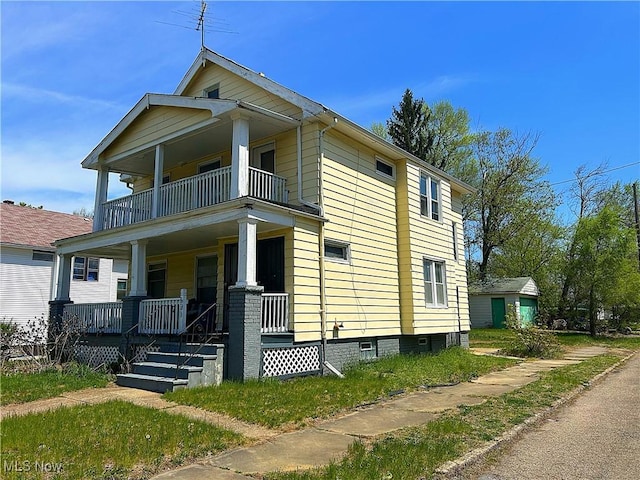 693 E 130th St, Cleveland, OH 44108 - view of front facade with a porch and a balcony