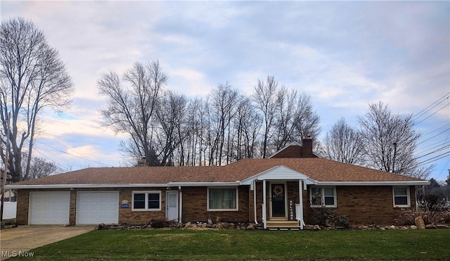 single story home featuring a front lawn, a chimney, concrete driveway, and an attached garage