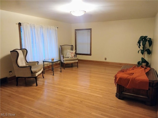 living area with light wood finished floors and baseboards