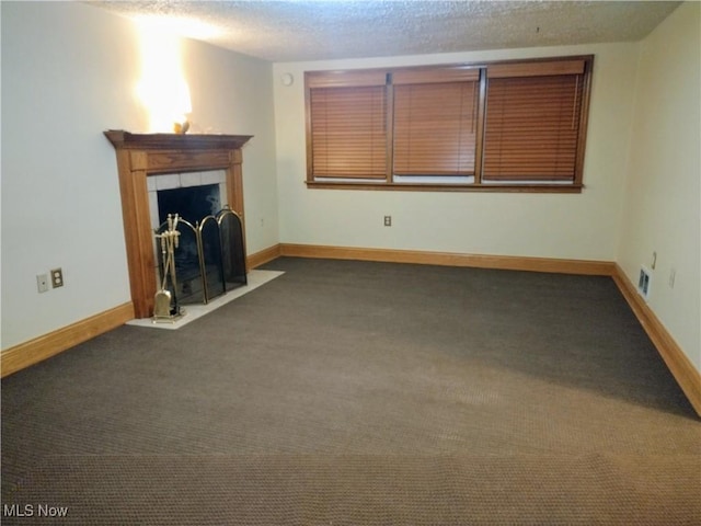 unfurnished living room with a fireplace, baseboards, and carpet floors
