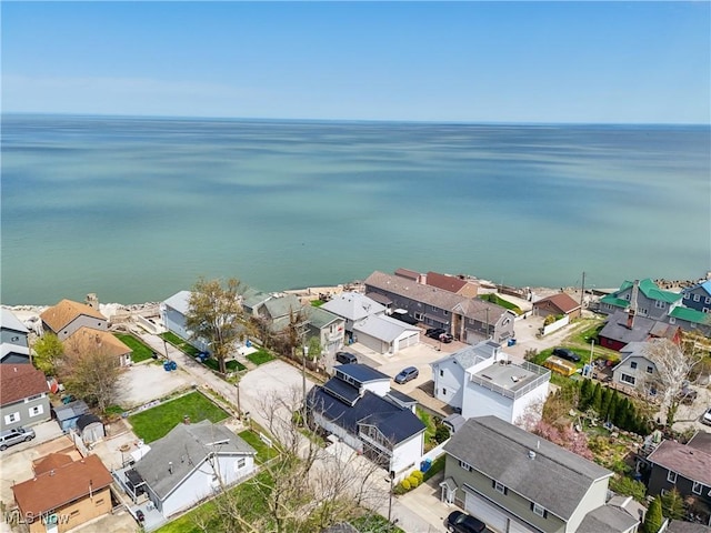 drone / aerial view featuring a water view and a residential view