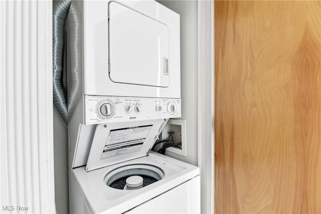 laundry room featuring stacked washer and dryer and laundry area