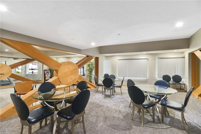 carpeted dining area with recessed lighting and a healthy amount of sunlight