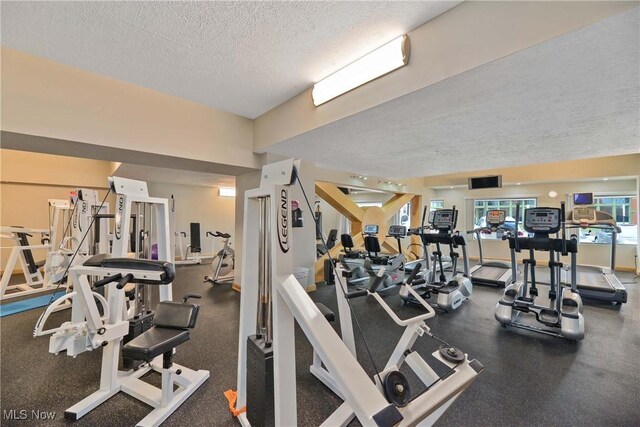 exercise room featuring a textured ceiling