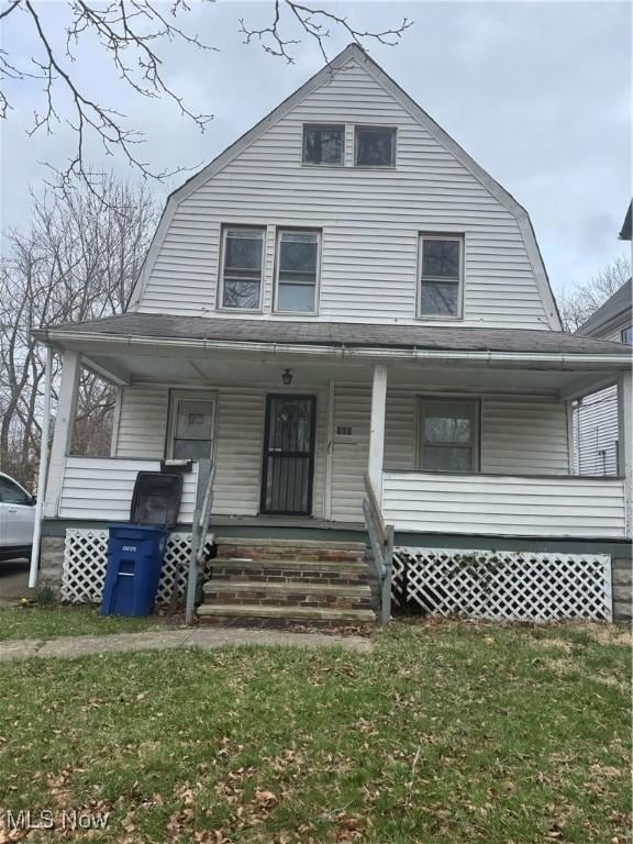 903 E 146th St, Cleveland, OH 44110 - colonial inspired home with covered porch, a front lawn, and a gambrel roof