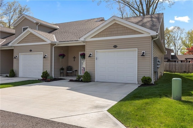 multi unit property with fence, driveway, roof with shingles, a front lawn, and an attached garage