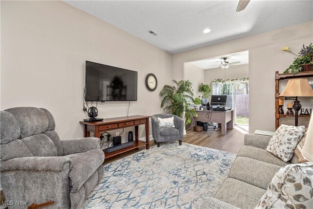 living area featuring recessed lighting, a ceiling fan, visible vents, and wood finished floors