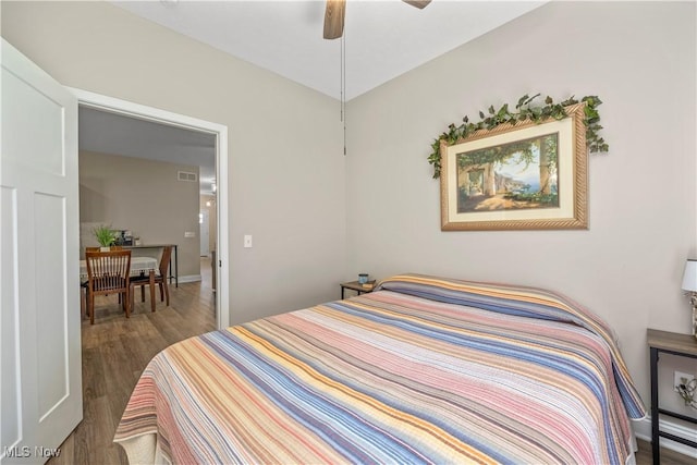 bedroom featuring visible vents, wood finished floors, and ceiling fan