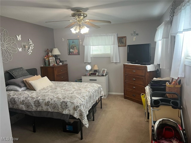 bedroom with ceiling fan and light carpet