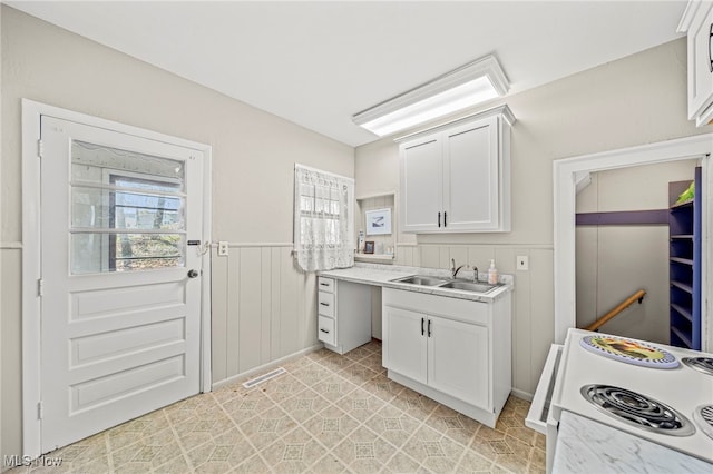1420 Bridge St, Ashtabula, OH 44004 - kitchen with white electric range, a wealth of natural light, light countertops, and a sink