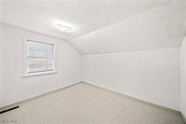 1420 Bridge St, Ashtabula, OH 44004 - bonus room with lofted ceiling, visible vents, carpet floors, and baseboards