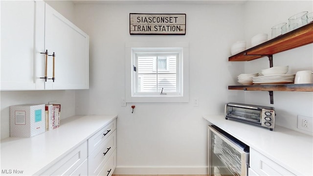 interior space with a toaster, wine cooler, and baseboards