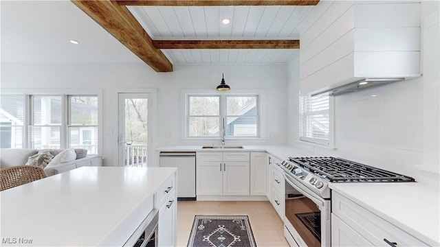 110 May Ct, Chagrin Falls, OH 44022 - kitchen with white dishwasher, stainless steel range with gas cooktop, a sink, plenty of natural light, and wooden ceiling with exposed beams