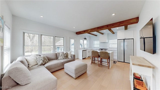 living area featuring recessed lighting, beamed ceiling, and light wood-type flooring