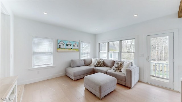 living room featuring recessed lighting, light wood finished floors, and baseboards