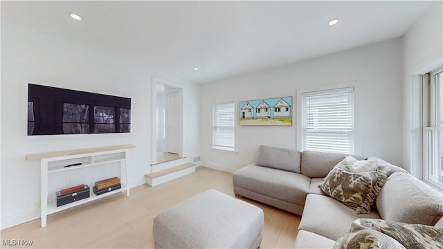 living area with recessed lighting, wood finished floors, and baseboards