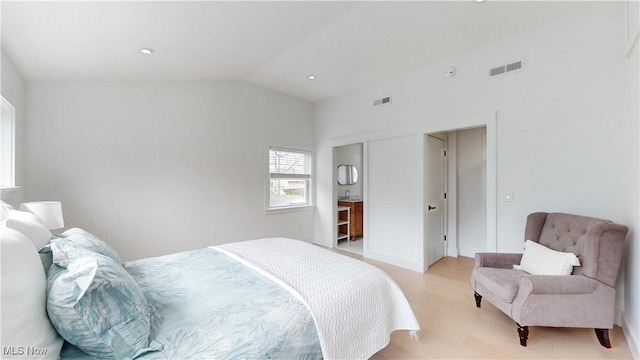 bedroom with visible vents, lofted ceiling, light wood finished floors, and recessed lighting