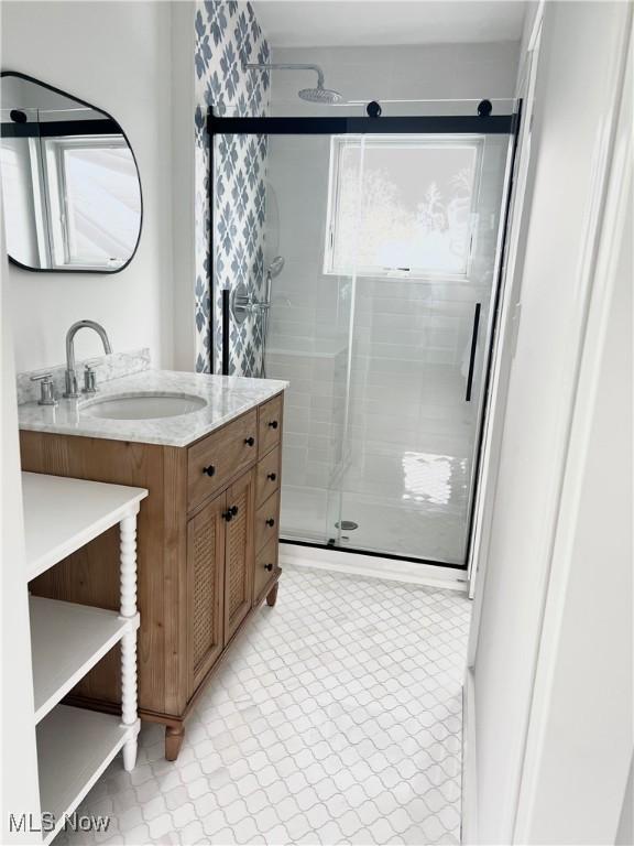 bathroom featuring a shower stall and vanity