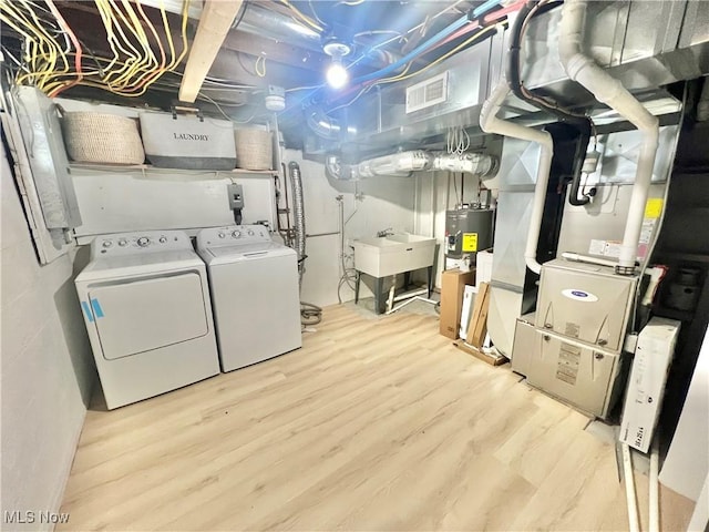 110 May Ct, Chagrin Falls, OH 44022 - unfinished below grade area with washer and clothes dryer, wood finished floors, a sink, and electric water heater