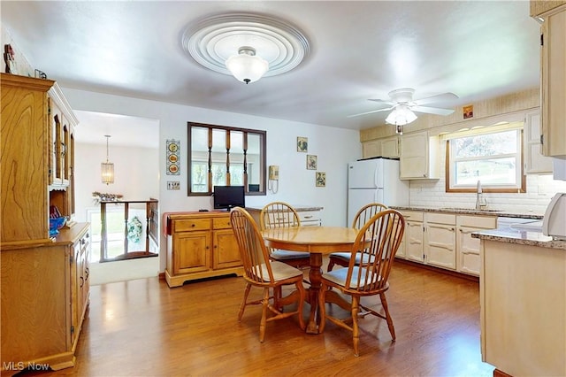 dining area featuring a ceiling fan and dark wood-type flooring