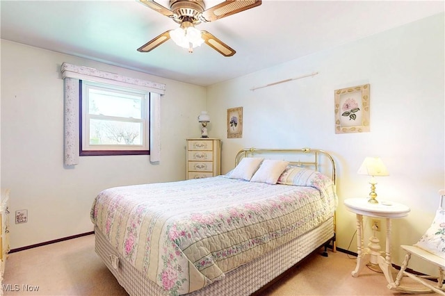carpeted bedroom with ceiling fan and baseboards