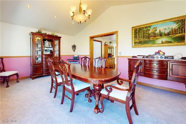 dining space with baseboards, a notable chandelier, lofted ceiling, and light colored carpet