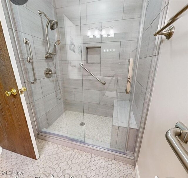 full bathroom with tile patterned flooring and a stall shower