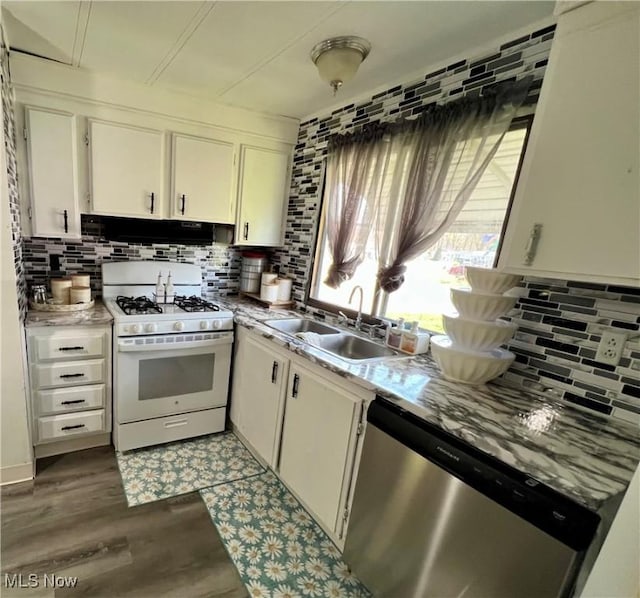 kitchen featuring stainless steel dishwasher, exhaust hood, decorative backsplash, white gas range oven, and a sink