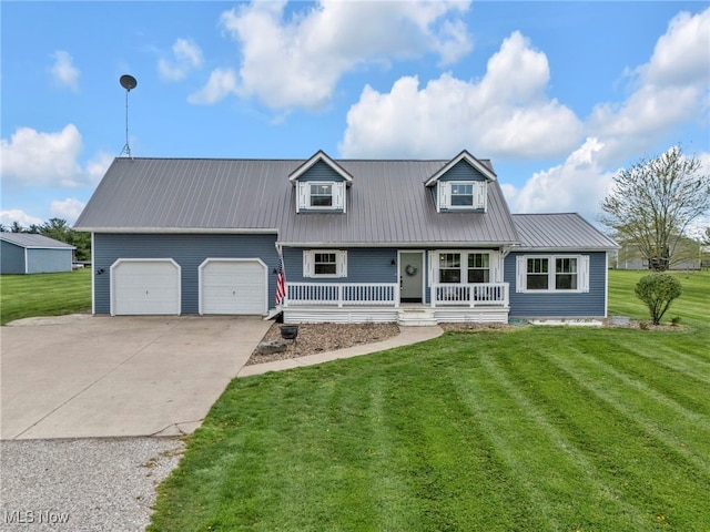 39233 Jones Rd, Litchfield, OH 44253 - view of front of house featuring a porch, a front lawn, metal roof, and an attached garage