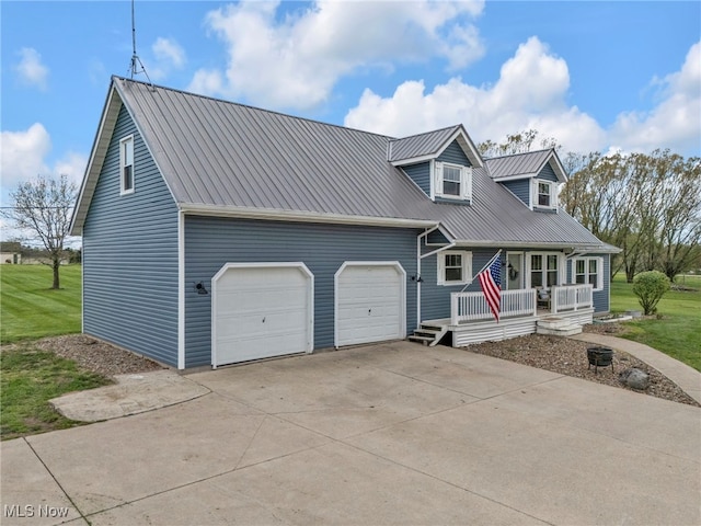 39233 Jones Rd, Litchfield, OH 44253 - cape cod home with covered porch, concrete driveway, a garage, and metal roof