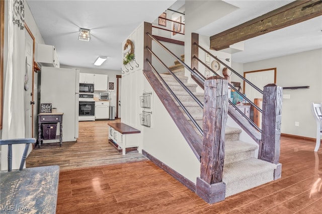 39233 Jones Rd, Litchfield, OH 44253 - stairway with baseboards, a toaster, and wood finished floors