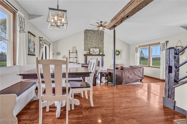 39233 Jones Rd, Litchfield, OH 44253 - dining room featuring wood finished floors, baseboards, vaulted ceiling with beams, and ceiling fan with notable chandelier