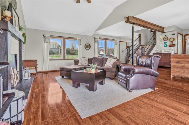 39233 Jones Rd, Litchfield, OH 44253 - living area featuring stairway, ceiling fan, vaulted ceiling, a fireplace, and wood finished floors