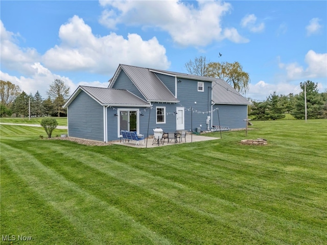 39233 Jones Rd, Litchfield, OH 44253 - back of house featuring a lawn, a patio area, and metal roof
