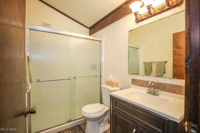 bathroom with a stall shower, toilet, vanity, and vaulted ceiling