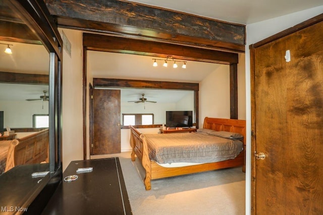 carpeted bedroom featuring track lighting