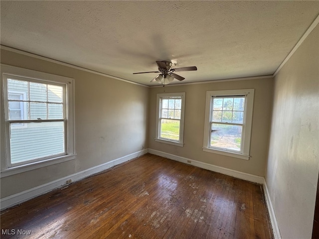 empty room featuring ornamental molding, ceiling fan, hardwood / wood-style flooring, and baseboards