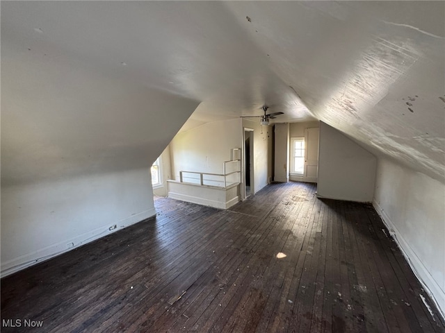 additional living space with baseboards, ceiling fan, lofted ceiling, and wood-type flooring