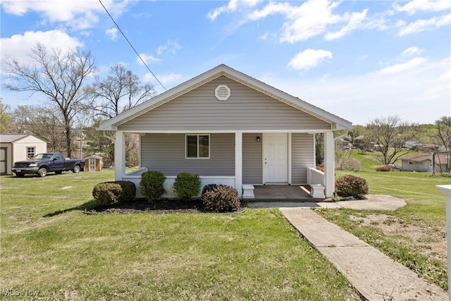 bungalow featuring a porch and a front yard
