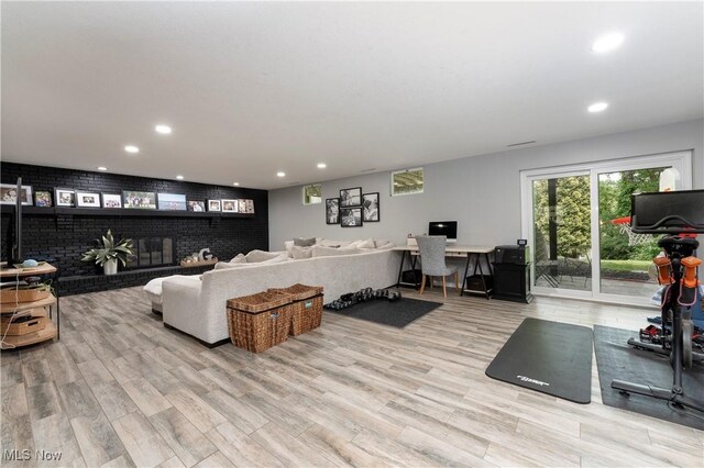 living area with recessed lighting and light wood-style floors