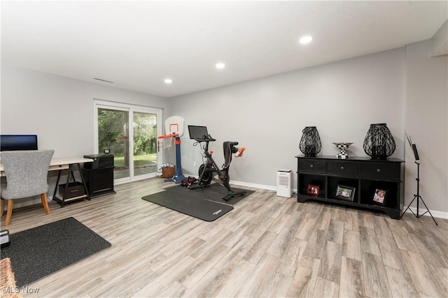 exercise area with baseboards, recessed lighting, and light wood-style floors