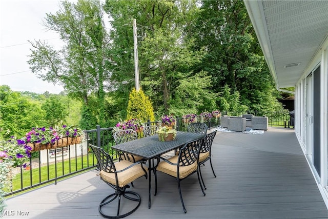 wooden terrace featuring an outdoor living space and outdoor dining area