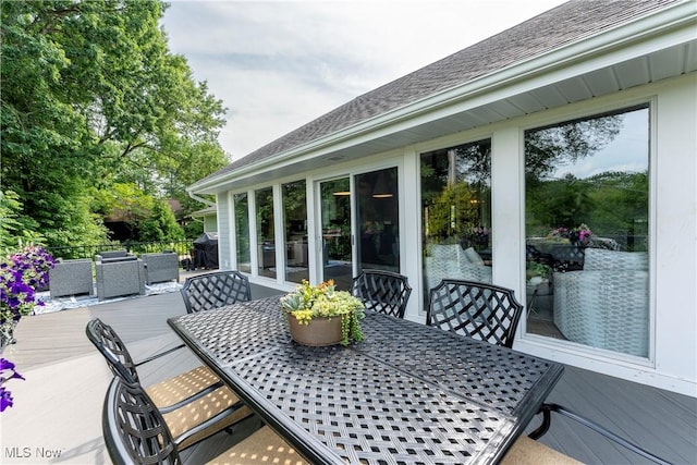 wooden terrace featuring outdoor dining space