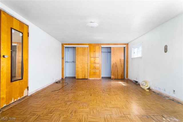 spare room featuring visible vents and baseboards