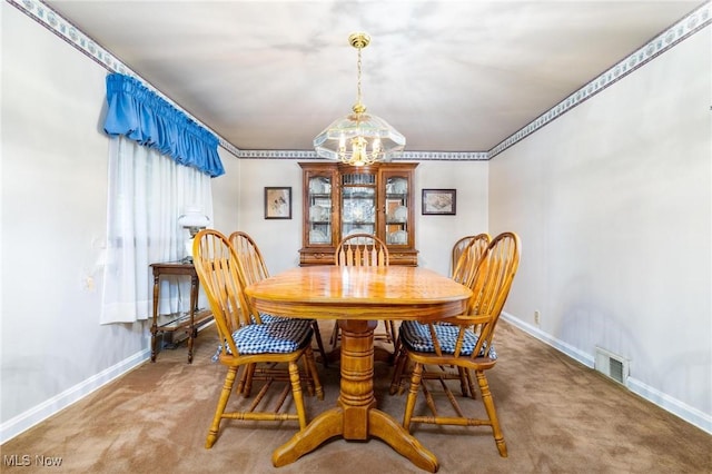 dining area featuring baseboards, visible vents, a chandelier, and carpet floors