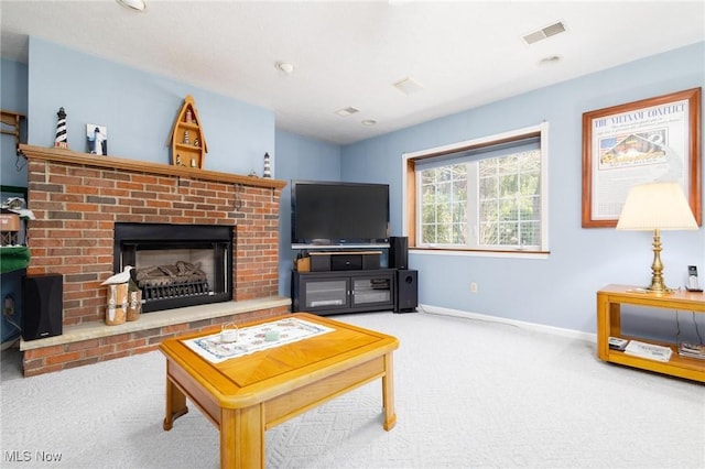 carpeted living area with a brick fireplace, visible vents, and baseboards