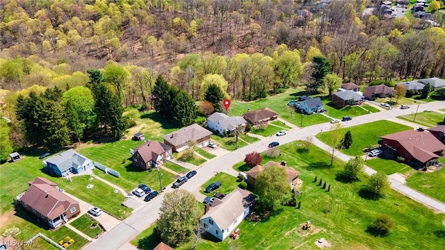birds eye view of property with a forest view and a residential view