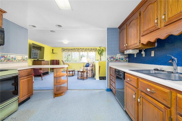 kitchen with black appliances, light countertops, and a sink