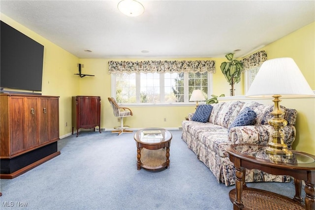 carpeted living room with baseboards